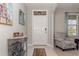 Bright entryway featuring a neutral color palette, a decorative console table, and a patterned accent chair at 9731 Pepper Tree Trl, Wildwood, FL 34785