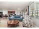 Open-concept living room features comfortable seating and seamless connection to kitchen and dining area at 9731 Pepper Tree Trl, Wildwood, FL 34785