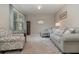 Inviting living room with neutral walls, plush carpeting, and comfortable seating, creating a cozy atmosphere at 9731 Pepper Tree Trl, Wildwood, FL 34785