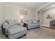 Bright living room featuring comfortable seating, neutral walls, and plush carpeting, perfect for relaxing at 9731 Pepper Tree Trl, Wildwood, FL 34785