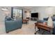 Stylish living room featuring comfortable blue sofas, modern decor, and large windows for natural light at 9731 Pepper Tree Trl, Wildwood, FL 34785
