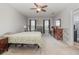 Spacious main bedroom with natural light, ceiling fan and neutral walls is ready for relaxation at 9731 Pepper Tree Trl, Wildwood, FL 34785