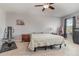 Airy primary bedroom provides ample space with plush carpet, modern fan, and tranquil atmosphere at 9731 Pepper Tree Trl, Wildwood, FL 34785