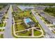 Aerial view of a planned community with a lake, playground, pool, and recreation area at 1025 Augustus Dr, Davenport, FL 33896