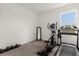 Minimalist exercise room with essential workout equipment and bright window offers space for fitness and healthy living at 1025 Augustus Dr, Davenport, FL 33896