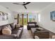 Cozy living room with comfortable leather furniture, large windows, and modern decor at 1025 Augustus Dr, Davenport, FL 33896