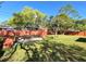 Spacious backyard with lush green grass and a storage shed, enclosed by a vibrant fence at 1062 Stillwater Ave, Deltona, FL 32725