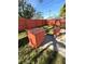 Lush backyard featuring an orange storage bin, lawn, and wood fencing at 1062 Stillwater Ave, Deltona, FL 32725