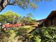 Expansive backyard featuring vibrant greenery, a storage shed, and a charming red fence at 1062 Stillwater Ave, Deltona, FL 32725