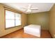 Bedroom featuring a bed, natural light, ceiling fan, and wood floors at 1062 Stillwater Ave, Deltona, FL 32725