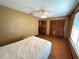 Bedroom featuring ceiling fan, wood floors, and double closet doors at 1062 Stillwater Ave, Deltona, FL 32725