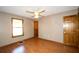 Empty bedroom showcasing wood floors, a ceiling fan, and natural light from the window at 1062 Stillwater Ave, Deltona, FL 32725