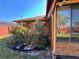 Backyard exterior view of brick home featuring a sunroom and garden at 1062 Stillwater Ave, Deltona, FL 32725