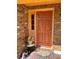 Close-up of the front door, showing a welcome mat and decorative potted plants at 1062 Stillwater Ave, Deltona, FL 32725