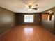 Hardwood floors and a ceiling fan in this spacious living room with natural light at 1062 Stillwater Ave, Deltona, FL 32725