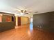 Hardwood floors and ceiling fans in this open-concept living room and dining space at 1062 Stillwater Ave, Deltona, FL 32725