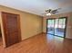 This living room includes laminate flooring, a closet, and sliding glass doors to an enclosed porch at 1062 Stillwater Ave, Deltona, FL 32725