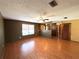 A living room featuring hardwood floors, a ceiling fan, and a view of the entrance at 1062 Stillwater Ave, Deltona, FL 32725