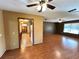 Open-concept living area showing laminate floors and a glimpse into the kitchen with unique saloon doors at 1062 Stillwater Ave, Deltona, FL 32725