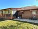 Outdoor patio area with a screened-in enclosure, tiled flooring, and brick exterior at 1062 Stillwater Ave, Deltona, FL 32725