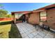 Outdoor patio area with a screened-in enclosure, tiled flooring, and brick exterior at 1062 Stillwater Ave, Deltona, FL 32725