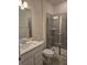 Stylish bathroom featuring gray tile in the shower, a modern vanity, and a toilet at 11151 Rising Sun St, Orlando, FL 32829