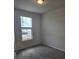 Comfortable bedroom with a large window, neutral walls, and gray carpet at 11151 Rising Sun St, Orlando, FL 32829