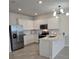 Modern kitchen boasting stainless steel appliances, white cabinets, and a convenient island at 11151 Rising Sun St, Orlando, FL 32829