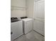 Functional laundry room equipped with a washer, dryer, and shelving for storage at 11151 Rising Sun St, Orlando, FL 32829