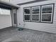 Private outdoor patio area featuring gray pavers and modern siding, with a hose for convenience at 11151 Rising Sun St, Orlando, FL 32829