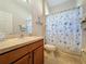 Bathroom featuring a vanity with storage, decorative shower curtain, and nautical theme at 120 Crepe Myrtle Dr, Groveland, FL 34736