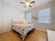 Cozy bedroom with hardwood floors, decorative bedding, and natural light at 120 Crepe Myrtle Dr, Groveland, FL 34736