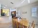 Cozy dining area featuring a wooden table, tile flooring, and a view into the adjacent kitchen area at 120 Crepe Myrtle Dr, Groveland, FL 34736