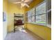 Bright dining area with yellow walls, ceiling fan, tile floor, and a large window overlooking the front yard at 120 Crepe Myrtle Dr, Groveland, FL 34736