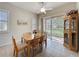 Bright dining area with tile floors, a wooden table set, and sliding glass doors leading to a screened-in patio at 120 Crepe Myrtle Dr, Groveland, FL 34736