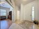 Bright foyer with tile flooring, leading to a living area with hardwood floors and an adjacent hallway at 120 Crepe Myrtle Dr, Groveland, FL 34736