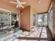 Inviting screened lanai featuring brick flooring, comfortable seating, and views of the lush backyard at 120 Crepe Myrtle Dr, Groveland, FL 34736