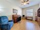 Bright office with wood floors, roll-top desk, and a comfortable armchair at 120 Crepe Myrtle Dr, Groveland, FL 34736