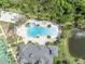 Aerial shot of community pool and clubhouse with tennis and basketball courts at 14209 Lake Live Oak Dr, Orlando, FL 32828