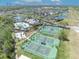 Aerial view showcasing the community pool, tennis courts, clubhouse, and pond at 14209 Lake Live Oak Dr, Orlando, FL 32828