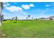 Expansive backyard features lush green grass and view of neighborhood playground at 14315 Crestavista Ave, Clermont, FL 34714