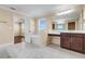 Primary bathroom features a soaking tub, double sink, and view to bedroom at 14315 Crestavista Ave, Clermont, FL 34714