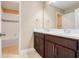 Bathroom featuring double vanity with modern fixtures, and an adjacent bathtub at 14315 Crestavista Ave, Clermont, FL 34714