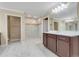 Bathroom featuring a double sink, white cabinets and a walk-in glass shower at 14315 Crestavista Ave, Clermont, FL 34714