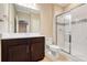 Bathroom featuring dark wood cabinets, a glass-enclosed shower, and tile floors at 14315 Crestavista Ave, Clermont, FL 34714