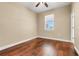 Bedroom with hardwood floors, a window, and neutral paint at 14315 Crestavista Ave, Clermont, FL 34714