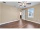 Bedroom with hardwood floors, ceiling fan, and an attached bathroom at 14315 Crestavista Ave, Clermont, FL 34714