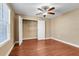 Bedroom featuring hardwood floors, ceiling fan and walk-in closet at 14315 Crestavista Ave, Clermont, FL 34714