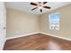 Bedroom with hardwood floors, ceiling fan and a window letting in natural light at 14315 Crestavista Ave, Clermont, FL 34714