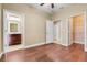 Bedroom featuring hardwood floors and access to both a closet and an ensuite bathroom at 14315 Crestavista Ave, Clermont, FL 34714